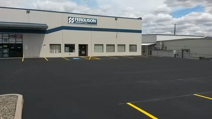 Sealcoated parking lot with yellow striping at a commercial building