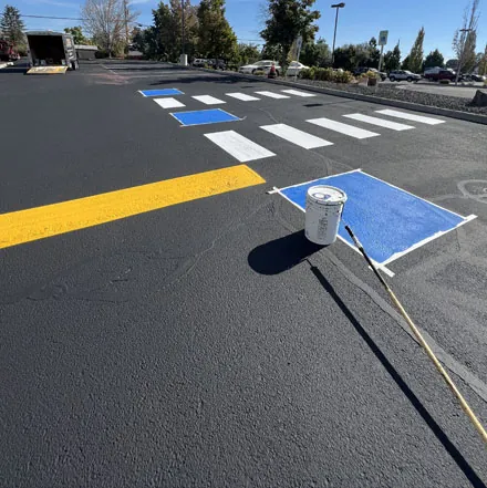 Pavement marking crew applying thermoplastic crosswalk striping
