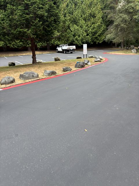 HOA parking lot in Mill Creek, WA: sealcoat and curb striping (photo 1)